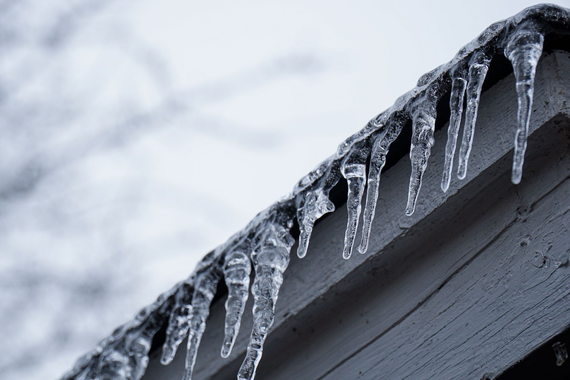 Icicles handing off the side of a roof.